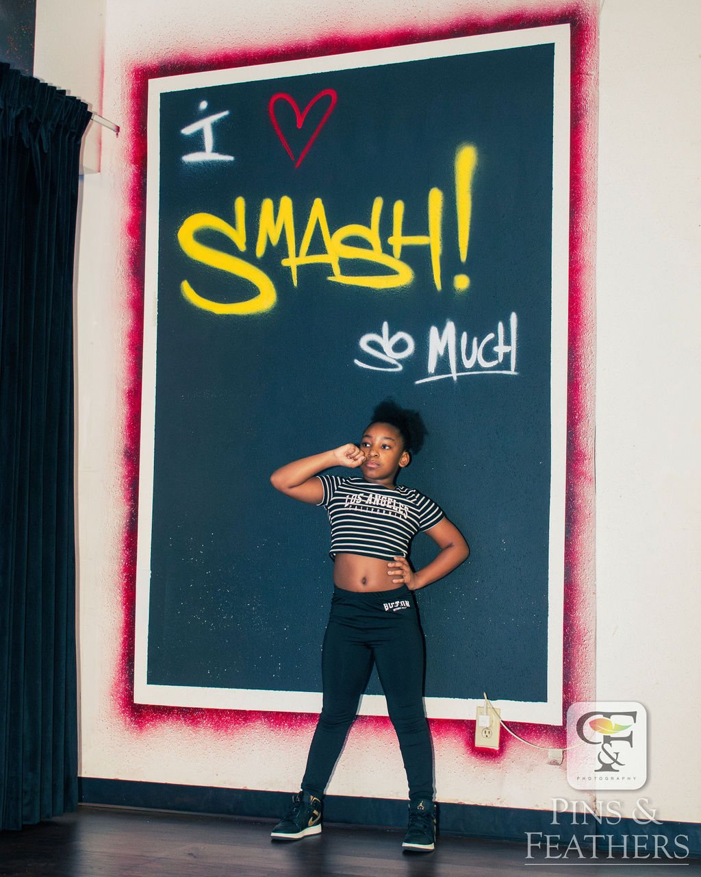 Project SMASH student by the I Love SMASH wall