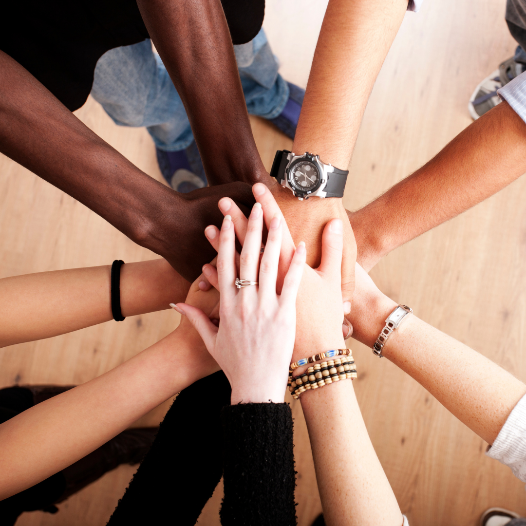 Community members joining hands together