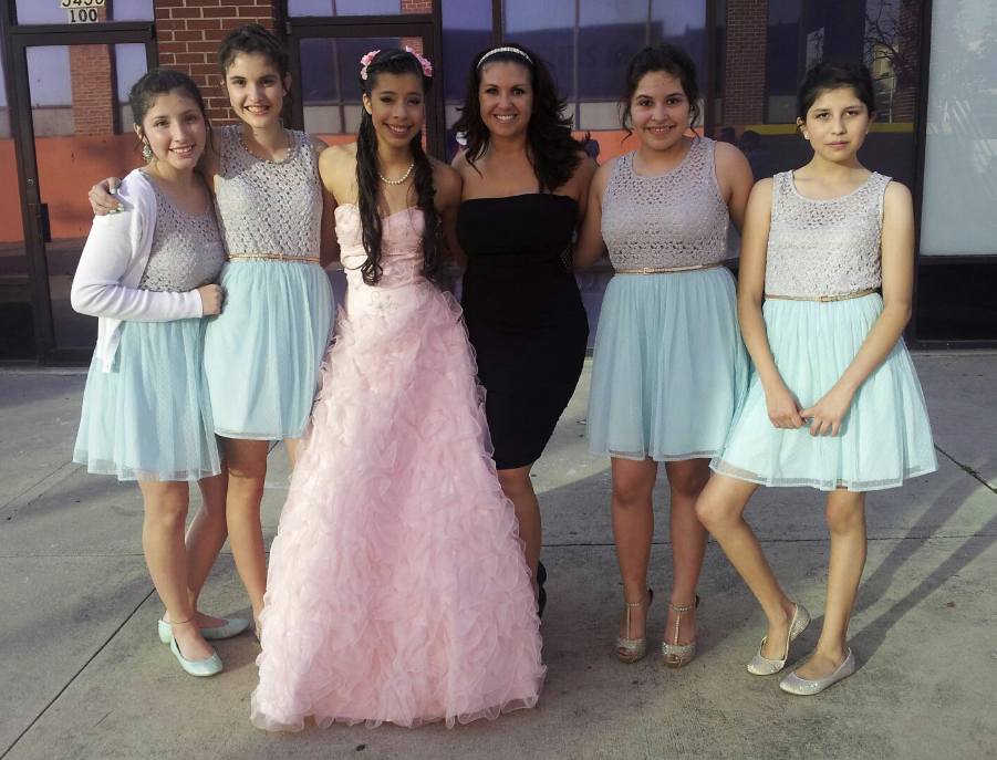 Quinceañera and her court outdoors
