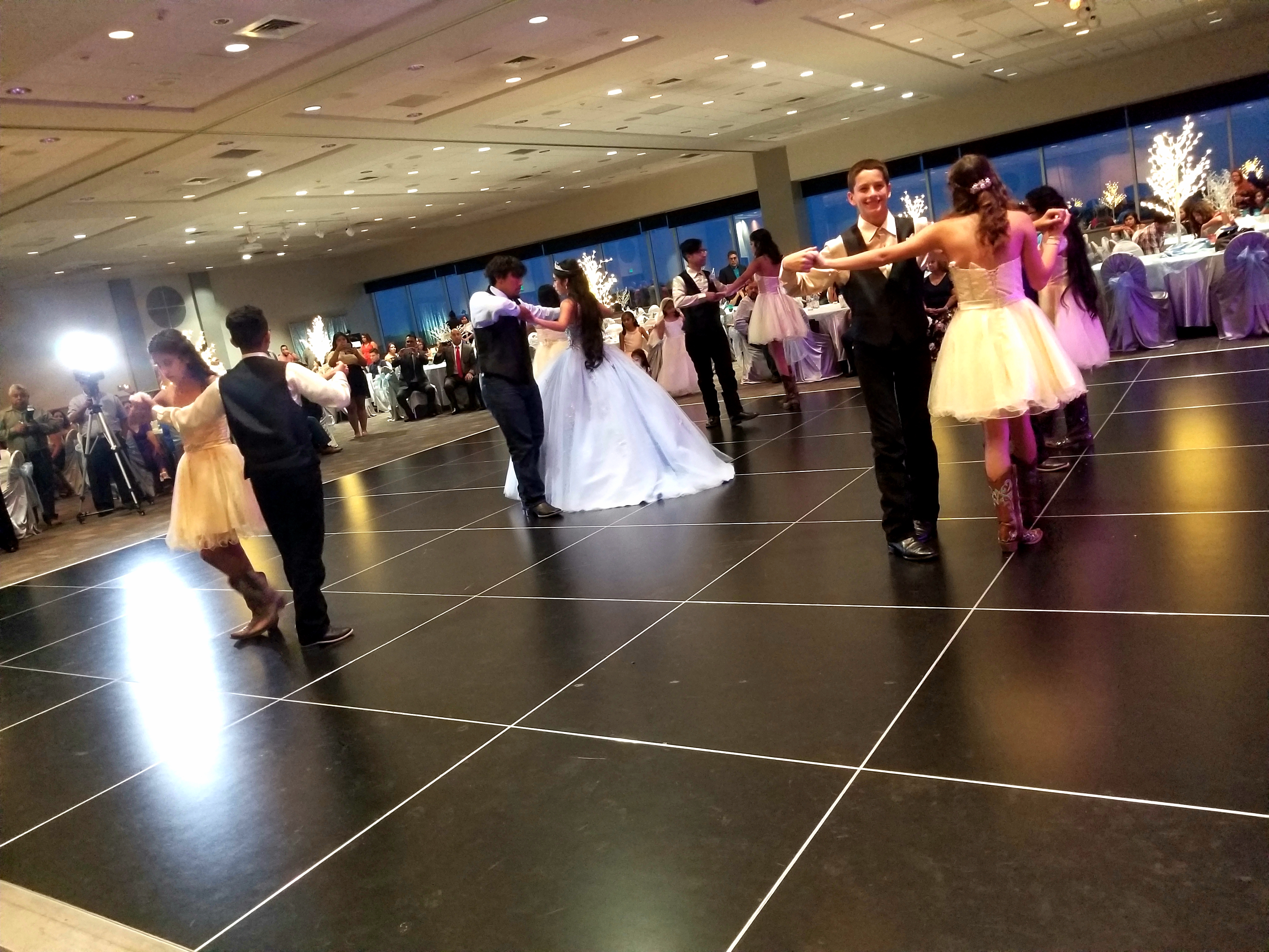 Quinceañera court dancing at the reception
